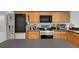 Kitchen showcases updated appliances, gray countertops, and plentiful wooden cabinetry with a view of the kitchen island at 4716 Block Island Ln, Clermont, FL 34714