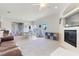Bright living room with a fireplace, a ceiling fan, and an adjacent dining area with sliding glass door at 4716 Block Island Ln, Clermont, FL 34714