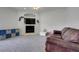 Comfortable living room with a fireplace, plush carpet, and a leather couch at 4716 Block Island Ln, Clermont, FL 34714