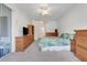 Spacious main bedroom with a private balcony, carpet floors, natural lighting, and wood furniture at 4716 Block Island Ln, Clermont, FL 34714