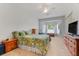 Cozy main bedroom featuring a bay window, ceiling fan, and neutral carpet flooring with wood furnishings at 4716 Block Island Ln, Clermont, FL 34714