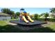 Community playground with dual slides and safety surfacing in a well-maintained neighborhood setting at 4716 Block Island Ln, Clermont, FL 34714
