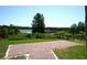 Picturesque community pond and dock surrounded by mature trees and lush greenery at 4716 Block Island Ln, Clermont, FL 34714