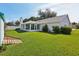 Spacious backyard featuring a well-manicured lawn and mature trees and shrubs at 508 Woodview Dr, Tavares, FL 32778