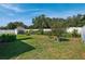 Spacious backyard features a storage shed, green lawn, and privacy fence at 508 Woodview Dr, Tavares, FL 32778