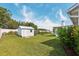 Well-maintained backyard with a storage shed, lush lawn, and a white privacy fence at 508 Woodview Dr, Tavares, FL 32778