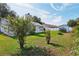 A charming backyard with lush green lawn and mature landscaping at 508 Woodview Dr, Tavares, FL 32778