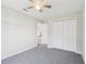 Bedroom with neutral carpet, a ceiling fan, and a closet at 508 Woodview Dr, Tavares, FL 32778