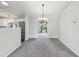 Open dining room with chandelier, neutral paint, and view into living spaces at 508 Woodview Dr, Tavares, FL 32778