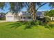 Charming single-Gathering home features a well-manicured lawn, two-car garage, and welcoming front porch at 508 Woodview Dr, Tavares, FL 32778