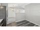 Kitchen featuring stainless steel appliances, open dining space, and hard surface floors at 508 Woodview Dr, Tavares, FL 32778
