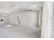 Spacious living room with vaulted ceiling, carpet, and access to other rooms at 508 Woodview Dr, Tavares, FL 32778