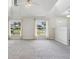 Bright living room with neutral carpet, large windows and high vaulted ceilings at 508 Woodview Dr, Tavares, FL 32778