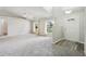 Bright living room with neutral carpet, large windows, and vaulted ceilings at 508 Woodview Dr, Tavares, FL 32778