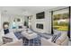 Staged living room features a fireplace, large windows, and sliding glass doors to the enclosed patio at 508 Woodview Dr, Tavares, FL 32778