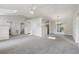 Bright and airy living room with neutral carpet, ceiling fan, and abundant natural light at 508 Woodview Dr, Tavares, FL 32778