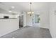 Open-concept living spaces with kitchen, dining area, and sliding glass door to the outside at 508 Woodview Dr, Tavares, FL 32778