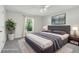 Staged main bedroom features a large bed, nightstands, and natural light at 508 Woodview Dr, Tavares, FL 32778