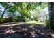 A large backyard with a wooden play set and mature trees for shade at 513 Barwick St, Wildwood, FL 34785
