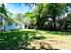 A spacious backyard with lush green grass, mature trees, and room for outdoor activities at 513 Barwick St, Wildwood, FL 34785