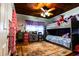 Comfortable bedroom featuring bunk beds, built in storage, colorful decor, and natural light at 513 Barwick St, Wildwood, FL 34785