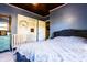 Bedroom with a gray headboard, crib, floral decorations, and ample natural light at 513 Barwick St, Wildwood, FL 34785