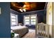 Bright bedroom with a large bed, crib, wood ceilings, and three windows offering plenty of natural light at 513 Barwick St, Wildwood, FL 34785