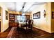 Elegant dining room with hardwood floors, a classic dining set, and built-in display cabinets at 513 Barwick St, Wildwood, FL 34785
