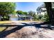 Charming single-story house with a screened porch, solar panels, and a spacious driveway at 513 Barwick St, Wildwood, FL 34785