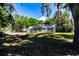 Cozy single-story home with solar panels, screened porch, RV, and expansive yard at 513 Barwick St, Wildwood, FL 34785