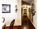 Inviting hallway featuring hardwood floors and wall decor at 513 Barwick St, Wildwood, FL 34785