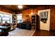 Functional home office with wood paneled walls, built-in shelves, and a modern desk setup at 513 Barwick St, Wildwood, FL 34785