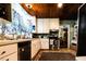 Efficient kitchen with stainless steel appliances, white cabinets, and a cozy dining area at 513 Barwick St, Wildwood, FL 34785