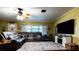 Cozy living room with hardwood floors, a plush sectional sofa, a large TV, and a charming cabinet at 513 Barwick St, Wildwood, FL 34785