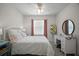 Bright bedroom featuring a ceiling fan, a comfortable bed, and a stylish vanity at 5333 Loblolly Ln, Wildwood, FL 34785