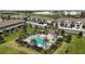 Inviting community pool with lounge chairs and palm trees, perfect for relaxation and socializing at 5333 Loblolly Ln, Wildwood, FL 34785