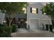 Two-story gray townhouse with two garages, a landscaped yard, and welcoming front entrance at 5333 Loblolly Ln, Wildwood, FL 34785