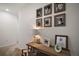 Upstairs hallway with a wooden console table, decorative lamp, and framed photos on the wall at 5333 Loblolly Ln, Wildwood, FL 34785