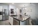 Stylish kitchen with island seating, stainless steel appliances, and a convenient pantry at 5333 Loblolly Ln, Wildwood, FL 34785