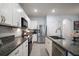 Bright kitchen with stainless steel appliances, island with sink, and white cabinetry at 5333 Loblolly Ln, Wildwood, FL 34785