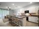 Modern kitchen featuring an island with seating, granite countertops, and white cabinets at 5333 Loblolly Ln, Wildwood, FL 34785