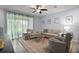 Welcoming living room showcasing sheer curtains, neutral tones, and plush seating area at 5333 Loblolly Ln, Wildwood, FL 34785