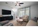 Inviting living room featuring a modern entertainment center, neutral tones, and plush seating area at 5333 Loblolly Ln, Wildwood, FL 34785