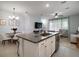 Open-concept layout with kitchen island, dining area, and comfortable living room at 5333 Loblolly Ln, Wildwood, FL 34785