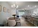 Open-concept living space with dining area, kitchen island, and comfortable living room at 5333 Loblolly Ln, Wildwood, FL 34785