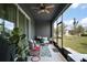This screened patio offers a serene outdoor space with a ceiling fan and comfortable seating at 5333 Loblolly Ln, Wildwood, FL 34785