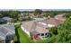 Aerial view highlights the home's backyard with a pergola-covered patio and mature landscaping at 541 Carrera Dr, The Villages, FL 32159