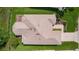 This home features a manicured lawn, mature trees, and long driveway at 541 Carrera Dr, The Villages, FL 32159
