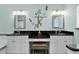 Stylish bathroom with double vanity, sleek mirrors, and decorative wall accents at 541 Carrera Dr, The Villages, FL 32159
