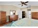 This bedroom features multiple dressers and access to other rooms at 541 Carrera Dr, The Villages, FL 32159